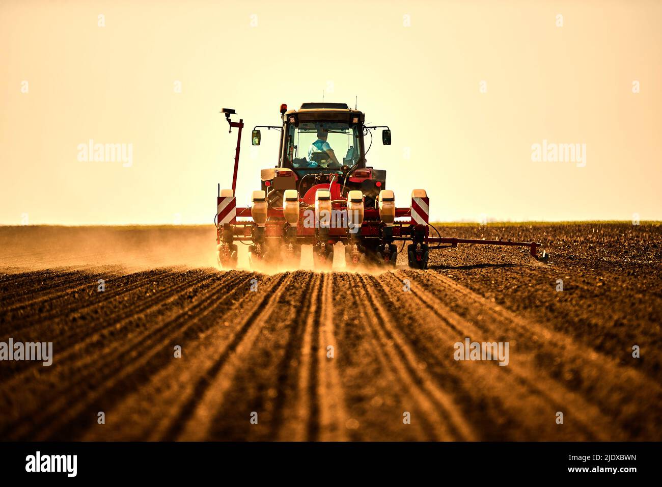 Farmer in tractor seeding soybean crops at arable field Stock Photo - Alamy