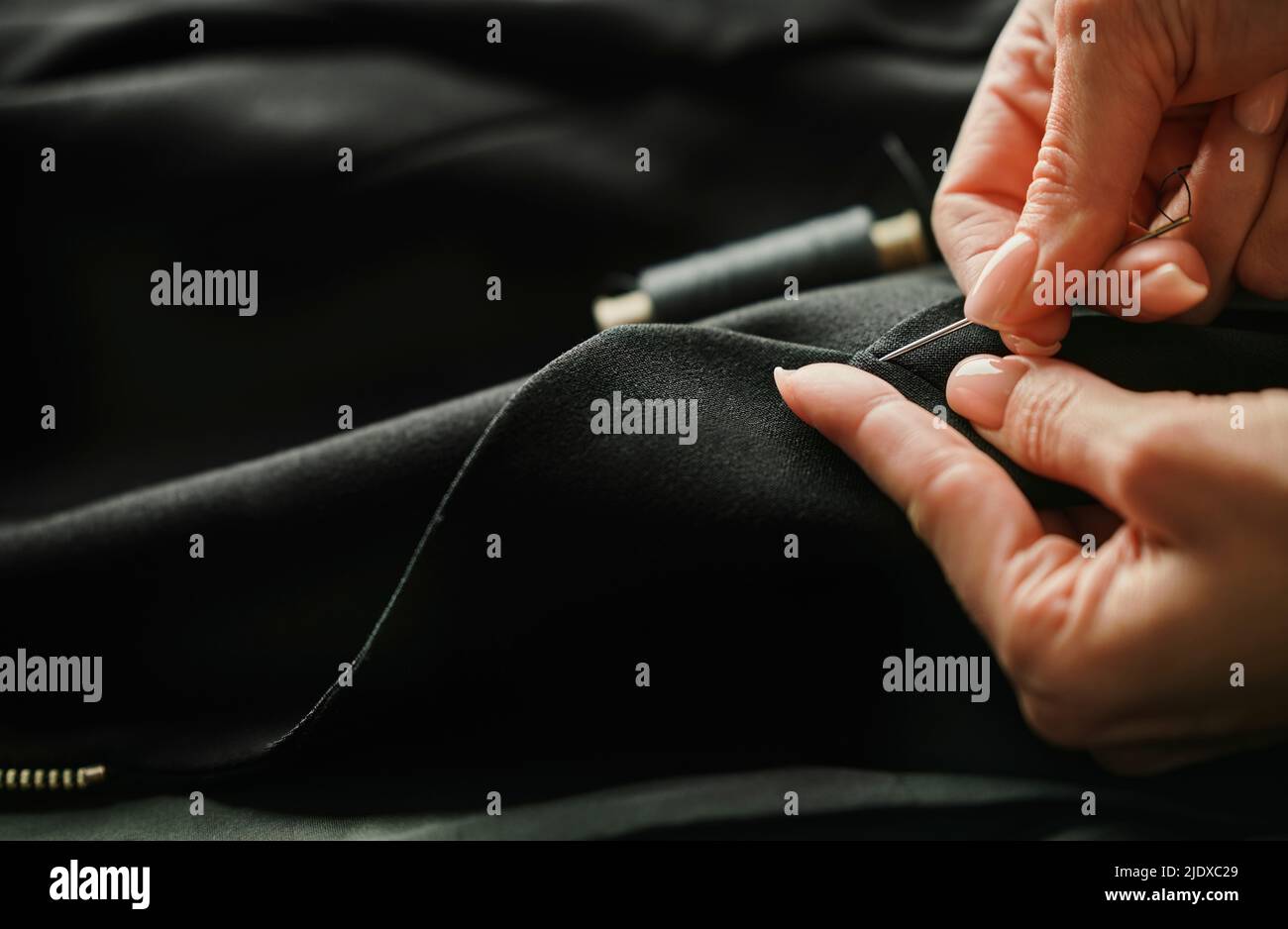 Hands of tailor finishing tailored suit Stock Photo - Alamy