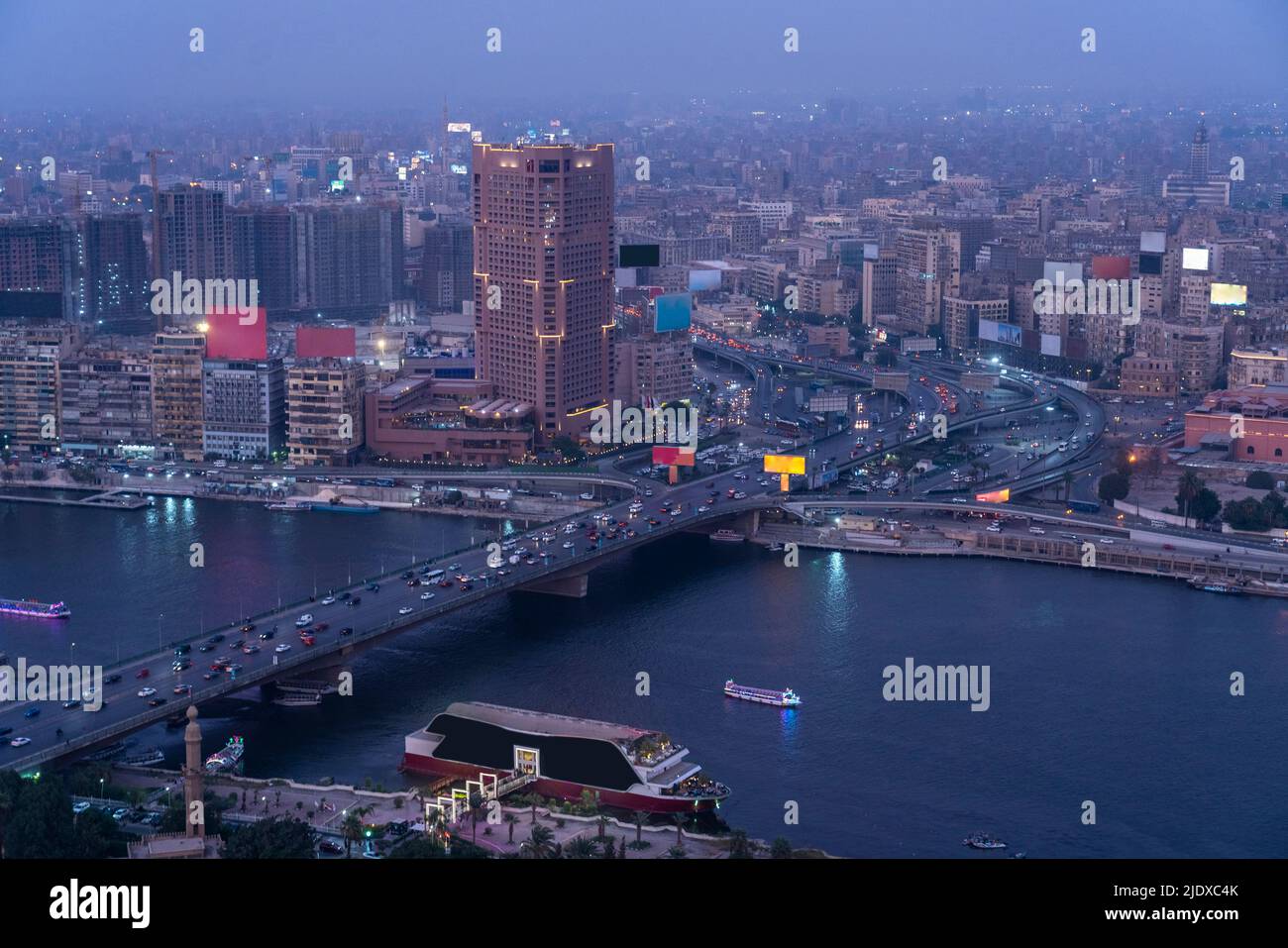 Egypt, Cairo, River Nile, Qasr El Nil Bridge and surrounding downtown buildings at dusk Stock Photo
