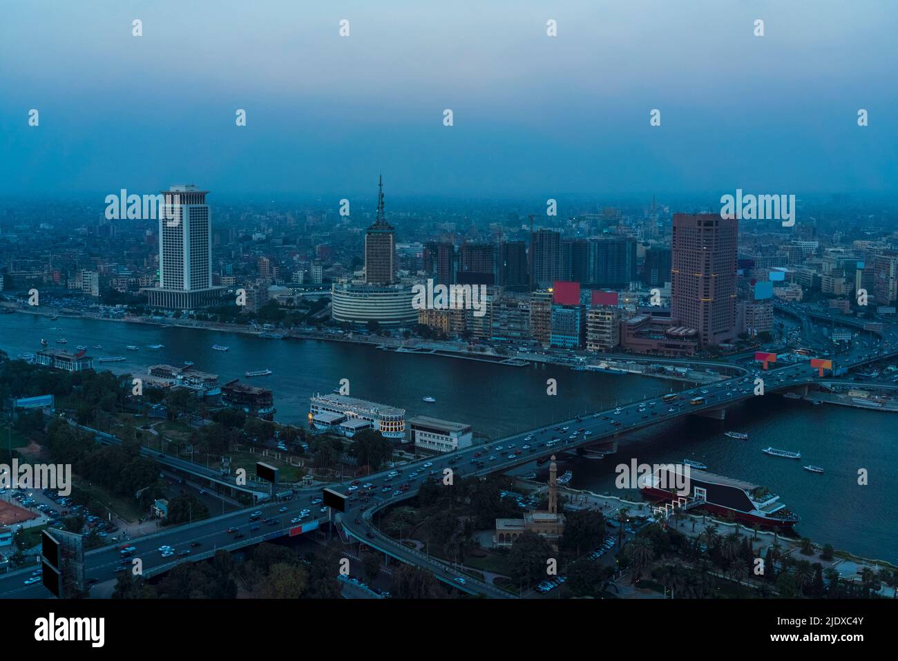 Egypt, Cairo, River Nile, Qasr El Nil Bridge and surrounding downtown buildings at dusk Stock Photo