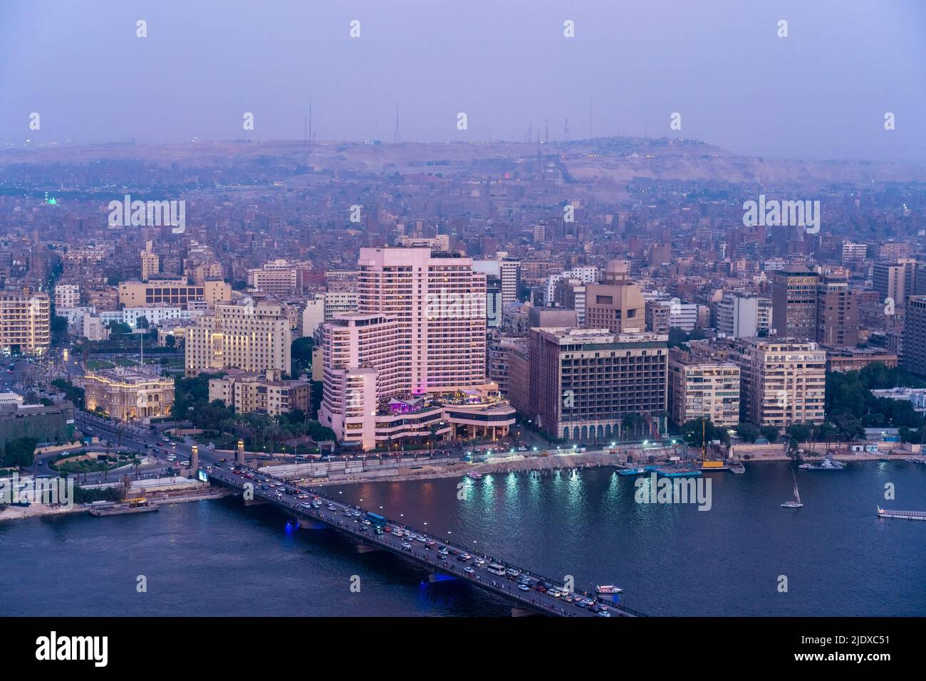 Egypt, Cairo, River Nile, Qasr El Nil Bridge and surrounding downtown buildings at dusk Stock Photo