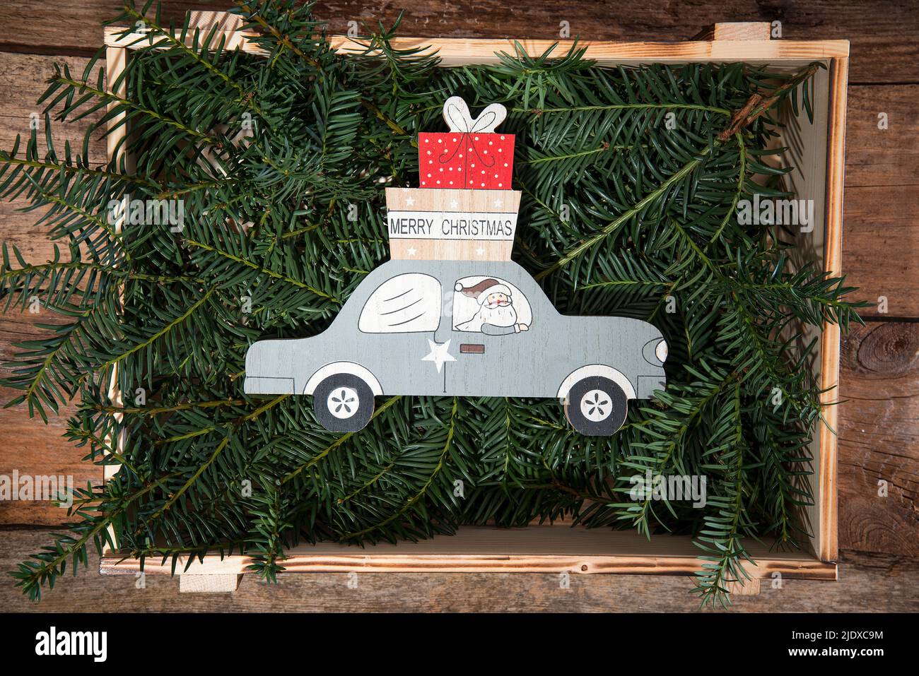 Crate filled with conifer twigs and Christmas decoration of Santa Claus ...