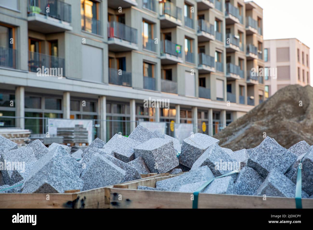 Germany, Bavaria, Munich, Stone blocks at construction site in front of apartments in Prinz-Eugen-Park complex Stock Photo