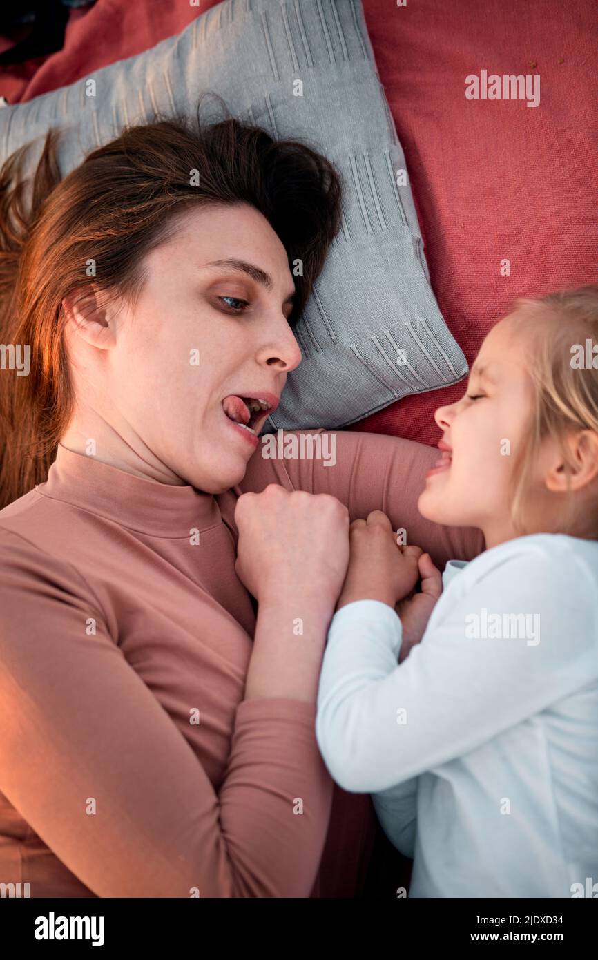 Mother and daughter making facial expressions on picnic Stock Photo