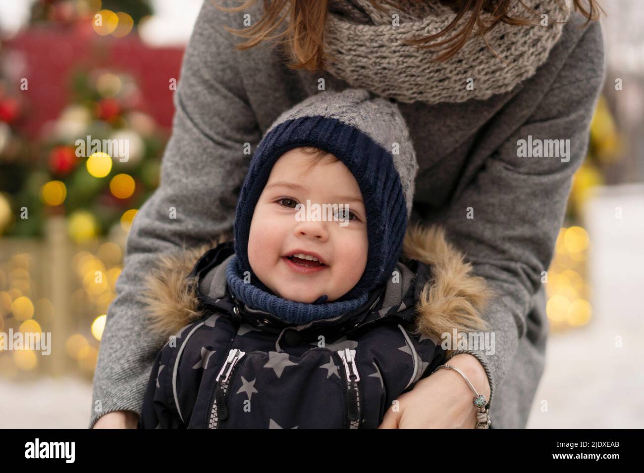 Cute boy with mother at Christmas market Stock Photo