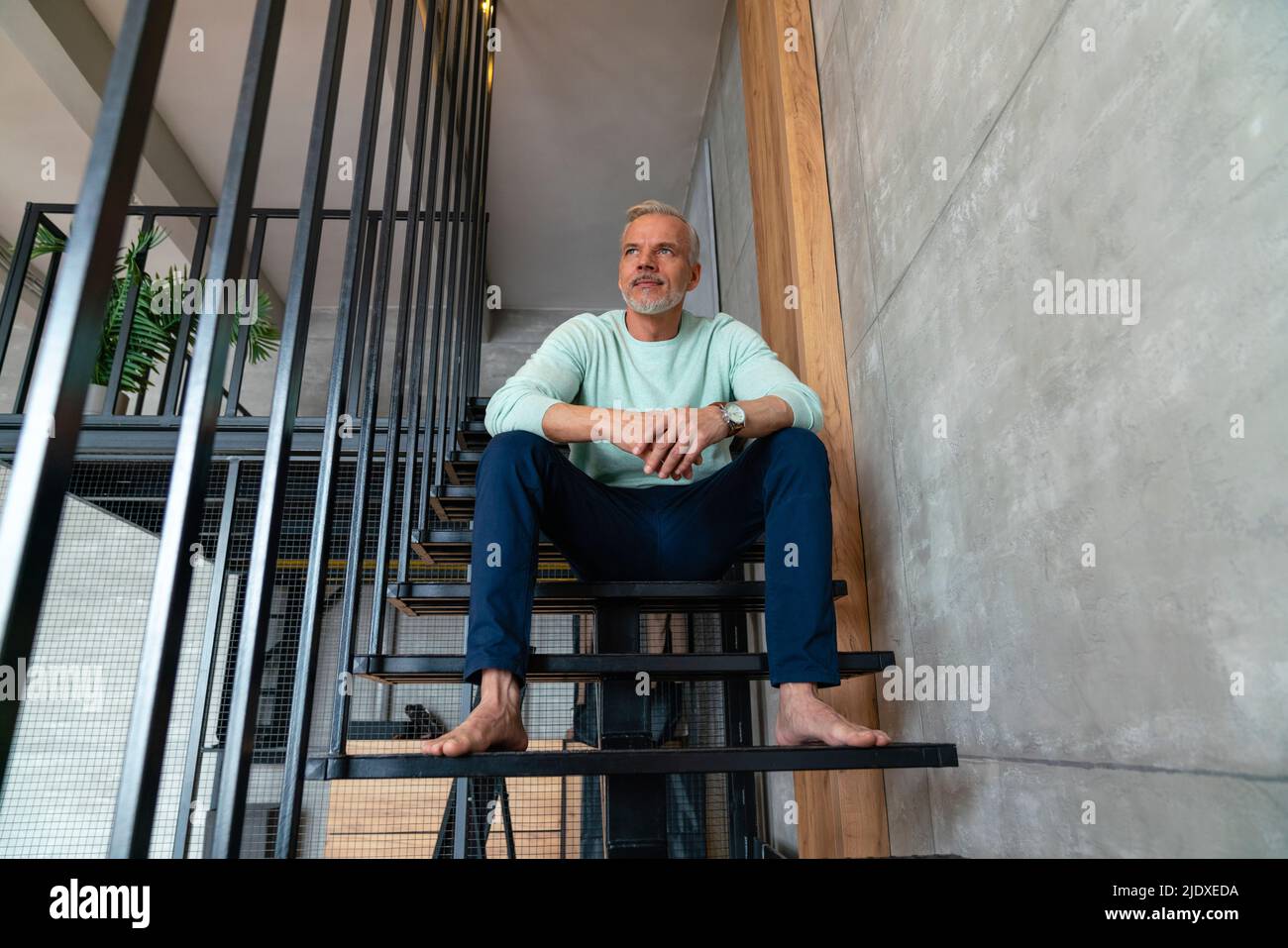 Man sitting on staircase hi-res stock photography and images - Alamy