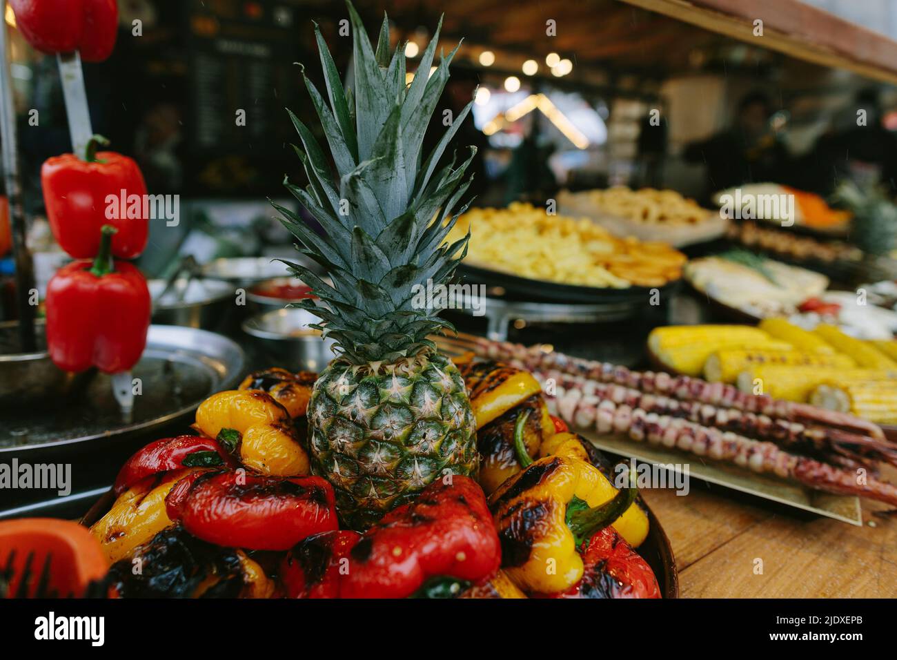 Pineapple amidst roasted bell peppers in restaurant Stock Photo Alamy
