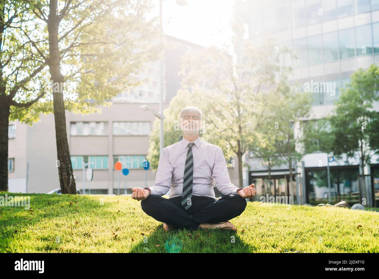 Man meditating cross legged hi-res stock photography and images - Alamy