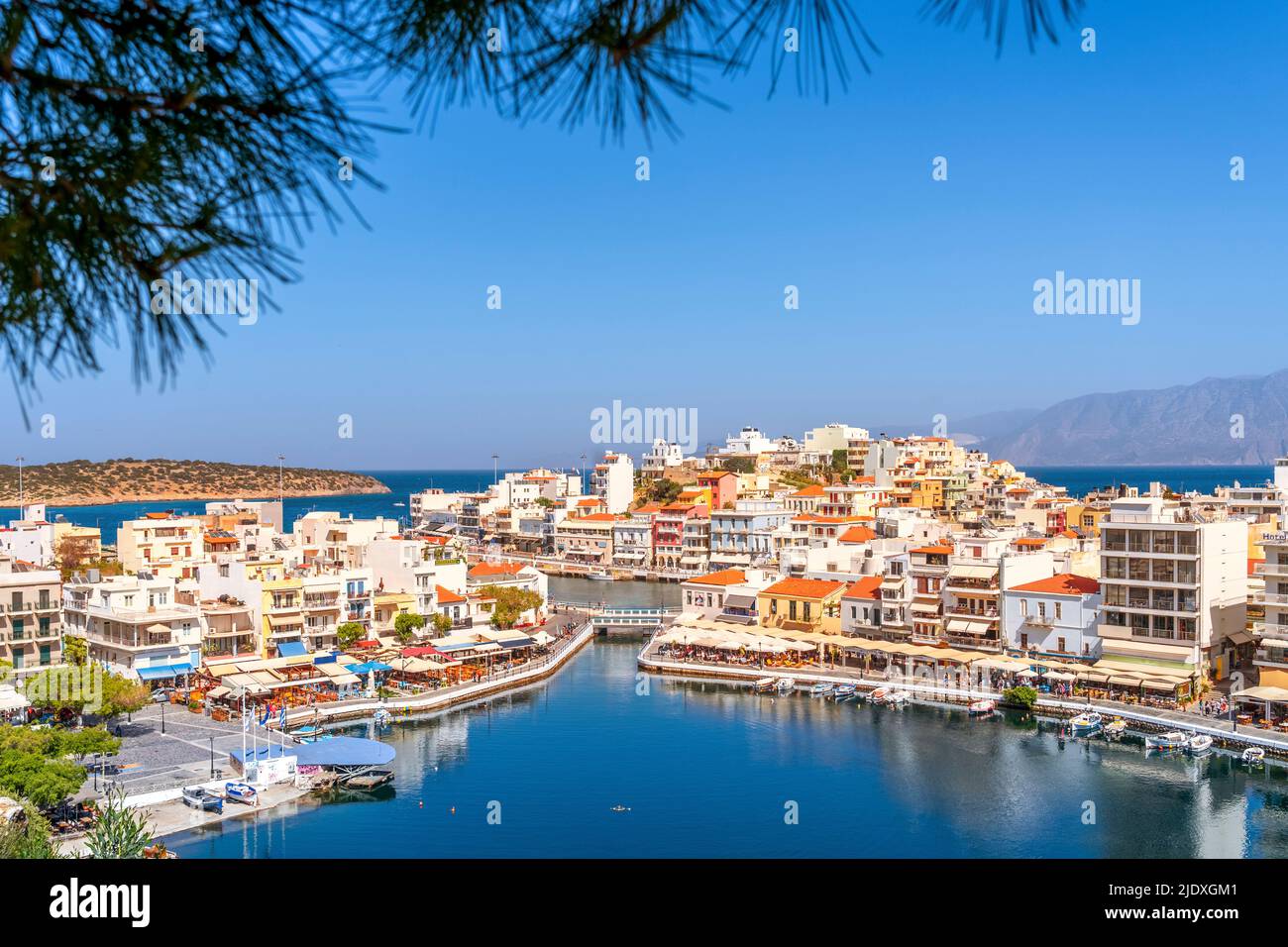 Greece, Crete, Agios Nikolaos, View of Lake Voulismeni and surrounding town in summer Stock Photo