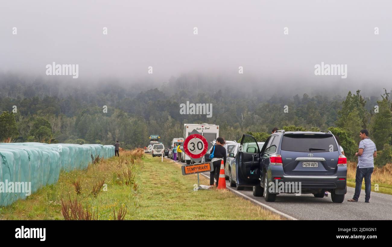 Franz Josef, New Zealand - February 12 2015: Road trip comes to a halt in the fog near Franz Josef New Zealand because of road works Stock Photo