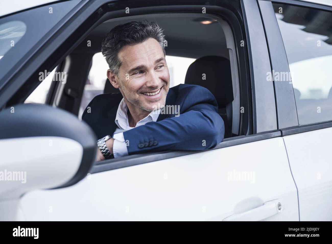 Smiling businessman sitting car hi-res stock photography and images - Alamy