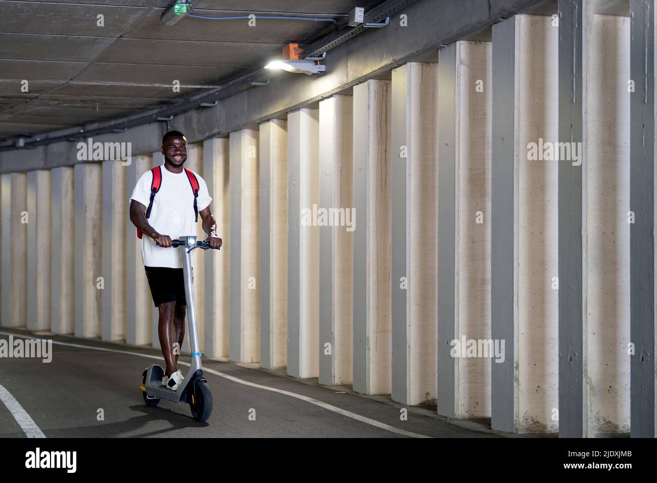 Man riding electric scooter hi-res stock photography and images - Alamy