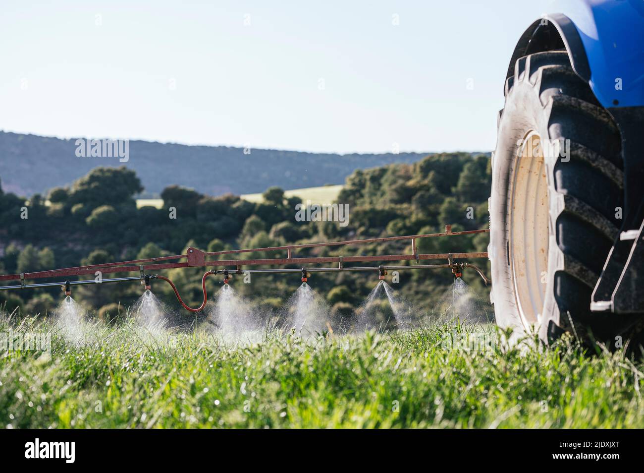 Crop sprayer spraying fertilizer on field Stock Photo Alamy