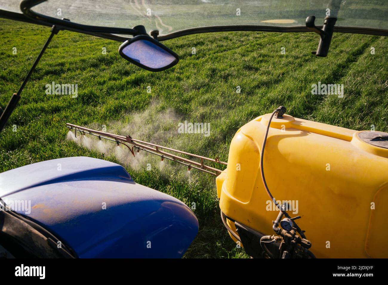 Crop sprayer spraying fertilizer on field Stock Photo Alamy