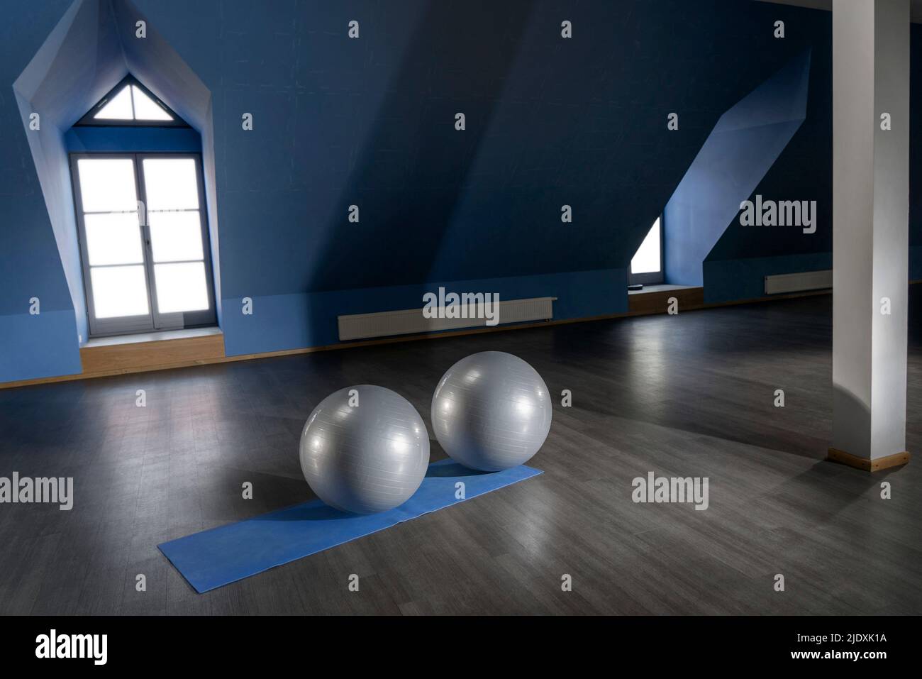 Gray color exercise balls on mat in empty fitness room Stock Photo