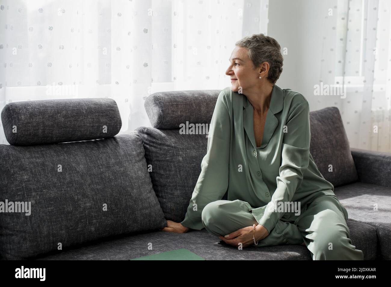 Mature daydreaming woman couch hi-res stock photography and images - Alamy
