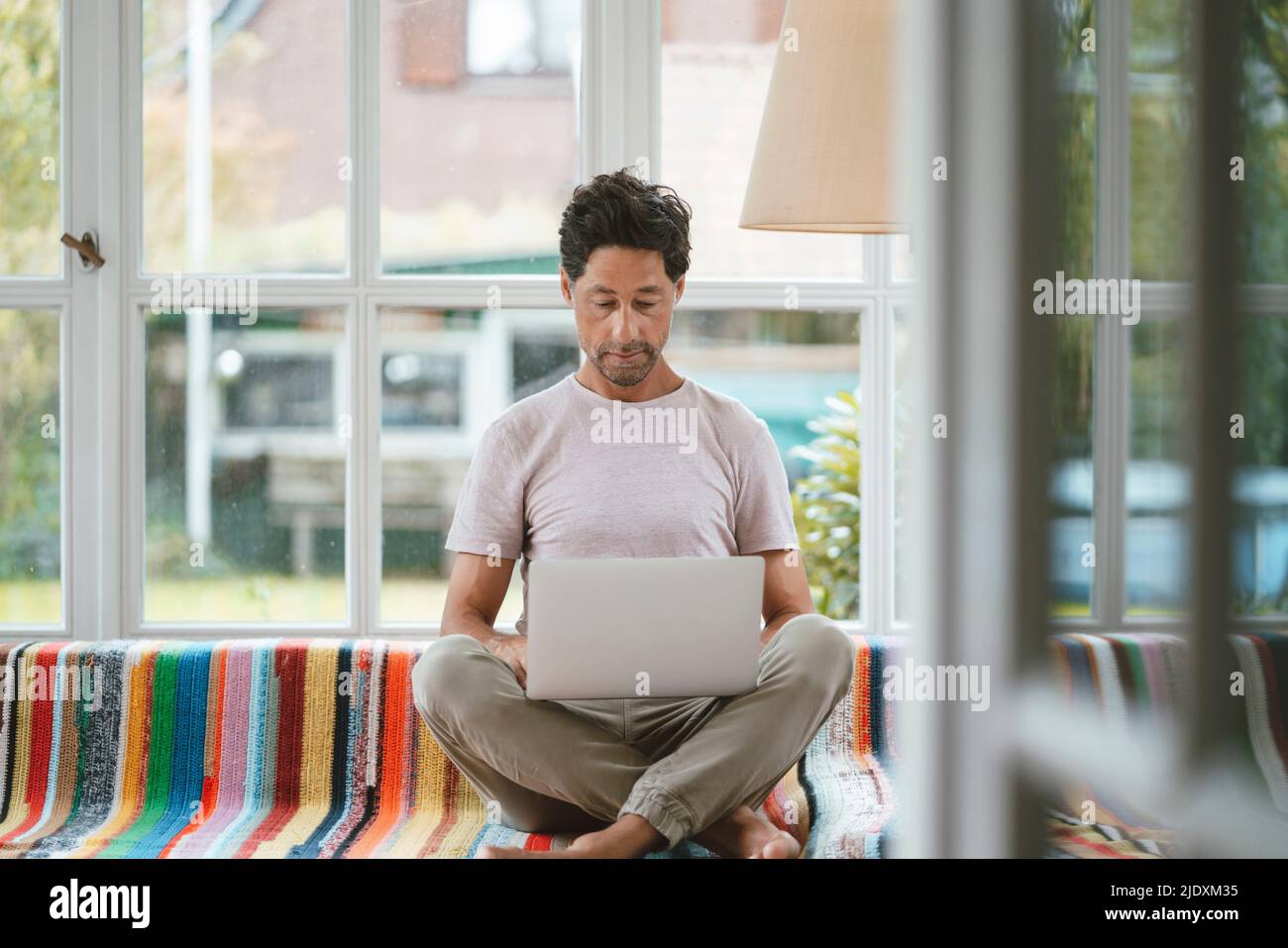 Mature man using laptop at home Stock Photo
