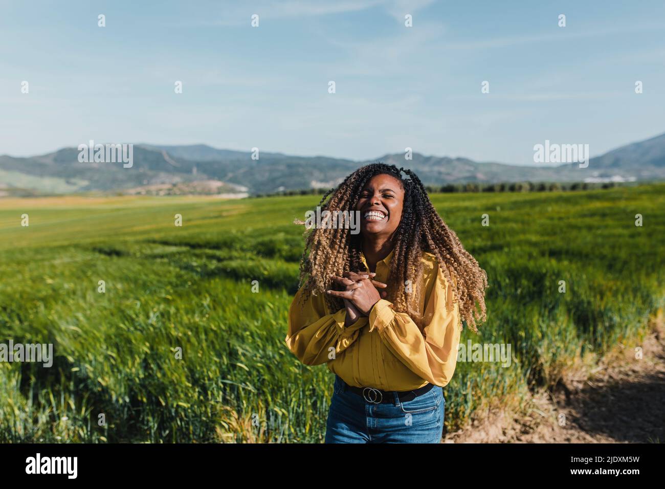 Cheerful woman with eyes closed standing in meadow Stock Photo - Alamy
