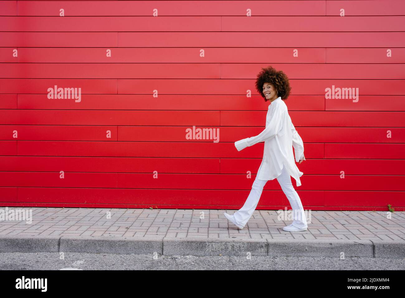 Woman walking sidewalk hi-res stock photography and images - Alamy