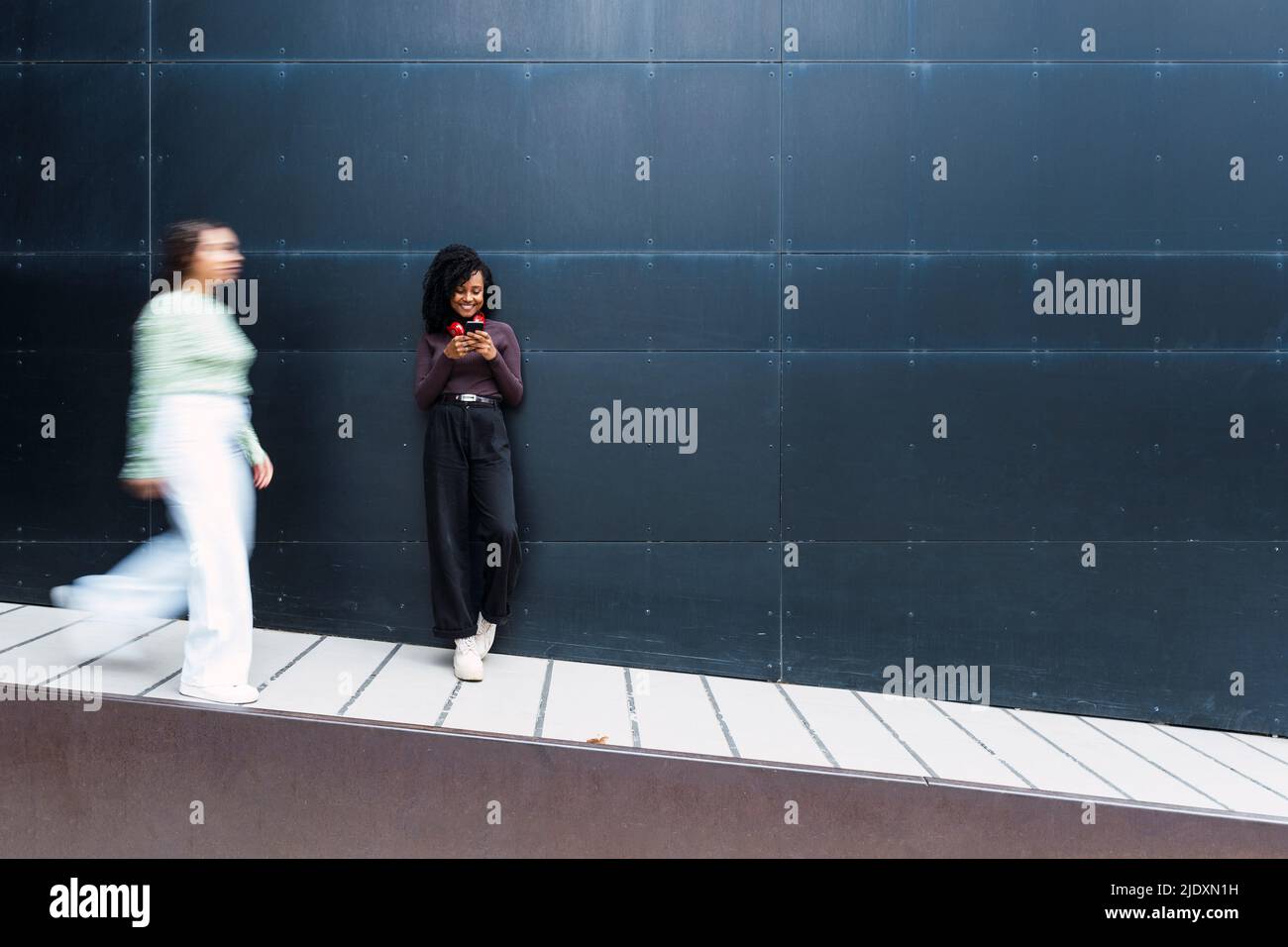 Afro young woman walking using hi-res stock photography and images - Alamy