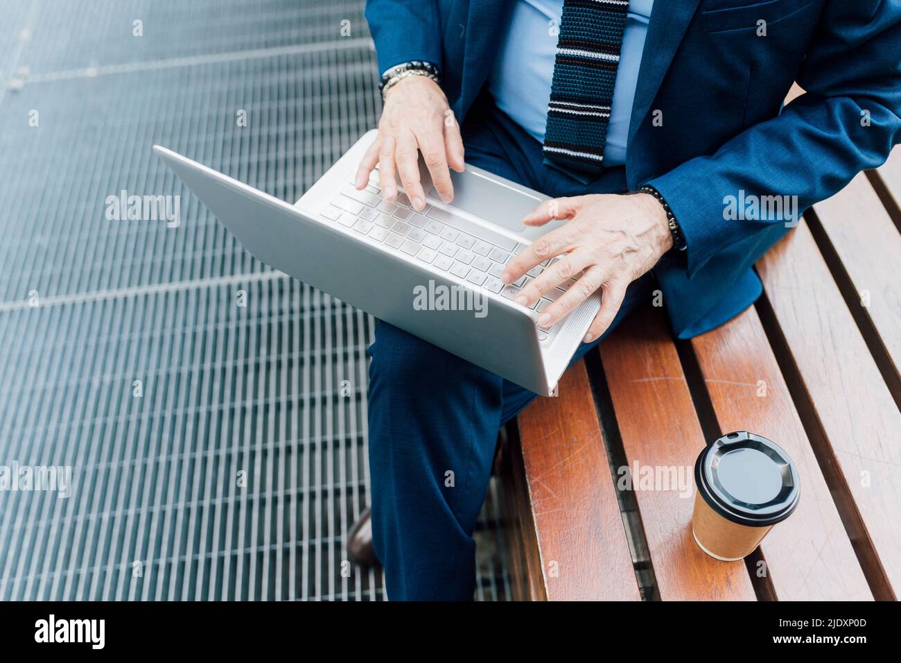 Businessman sitting on bench park working on laptop hi-res stock ...