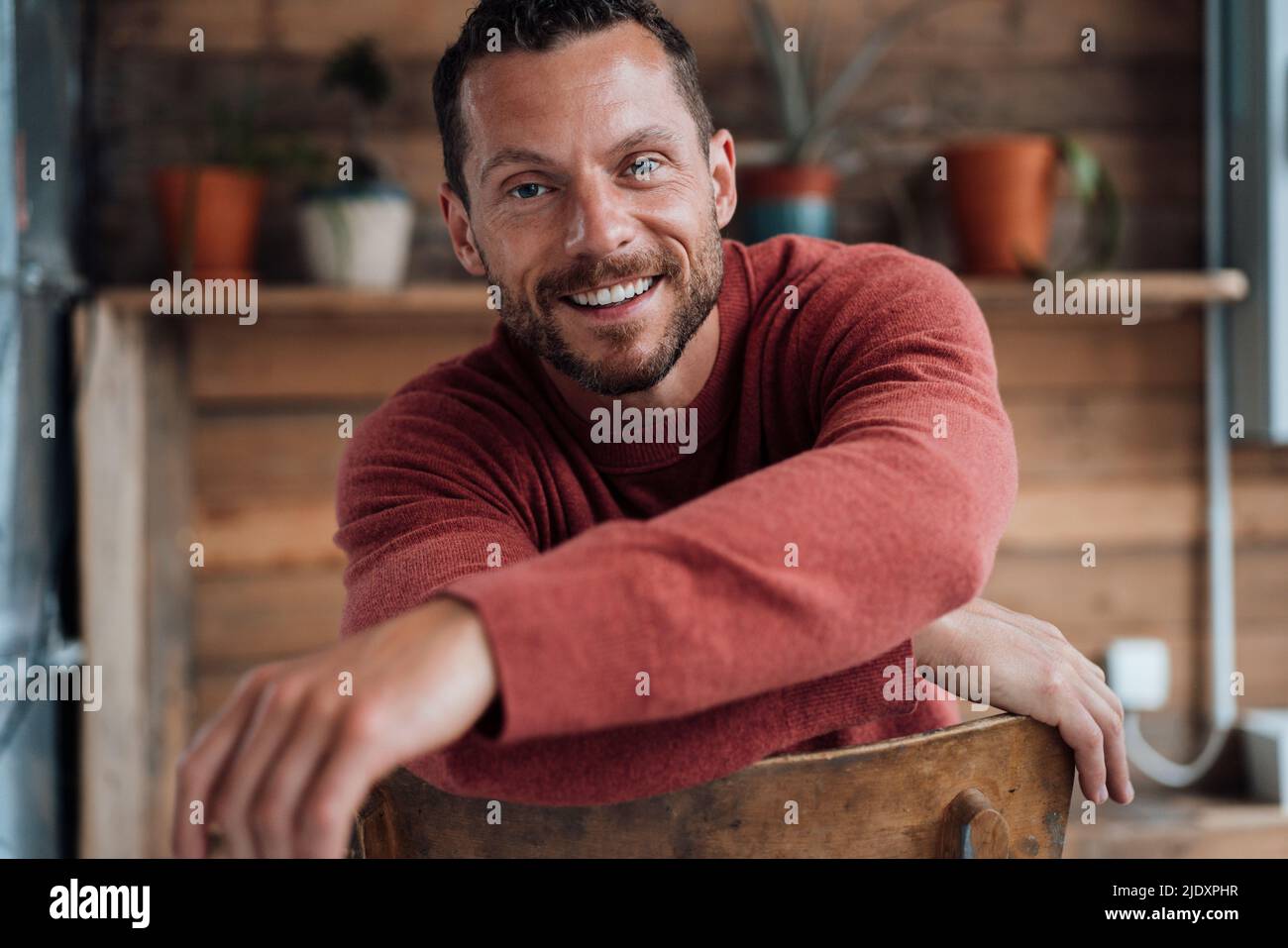 Happy mature man sitting on chair Stock Photo - Alamy