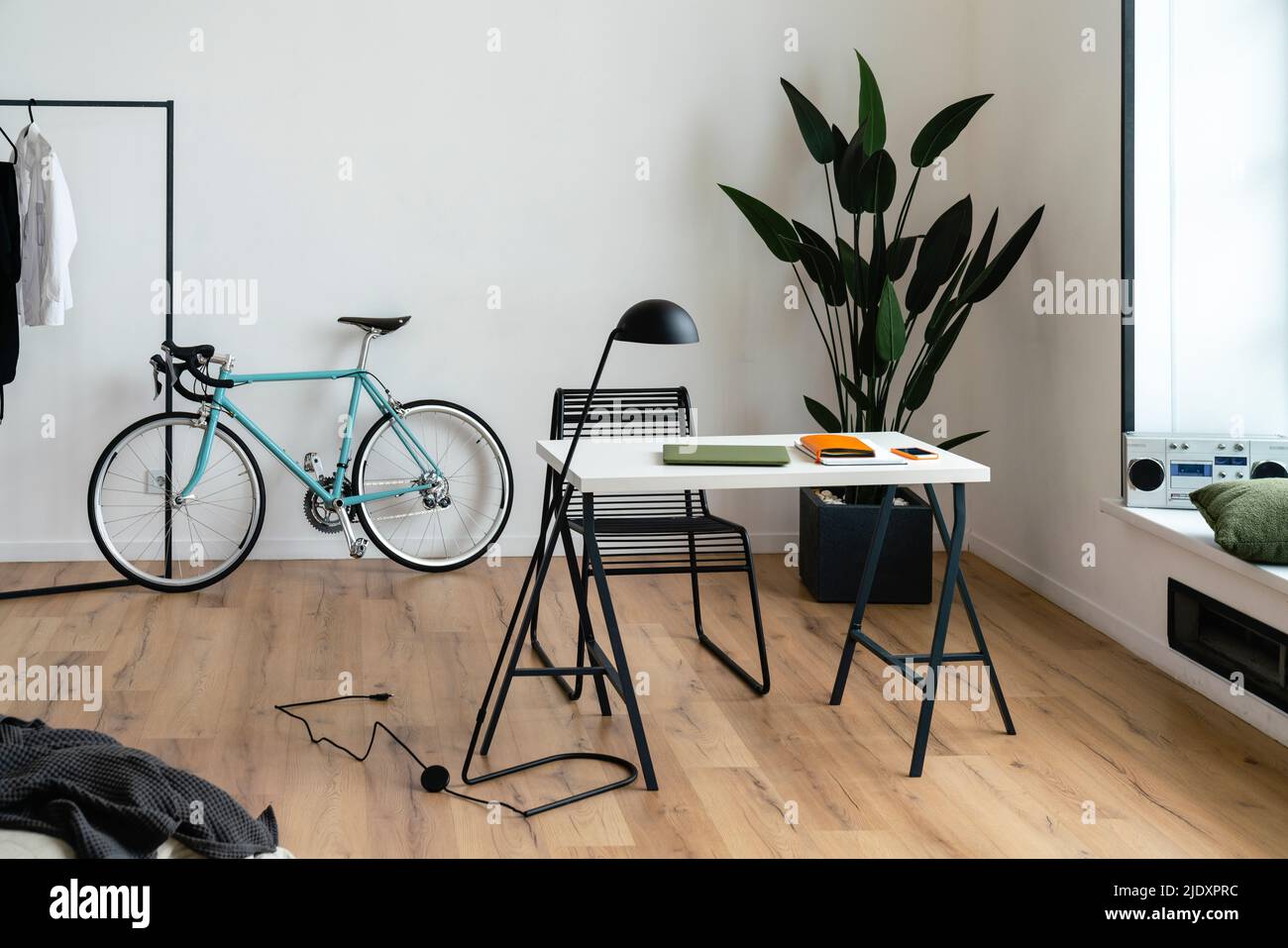 Interior of living room with bicycle, chair and desk Stock Photo Alamy