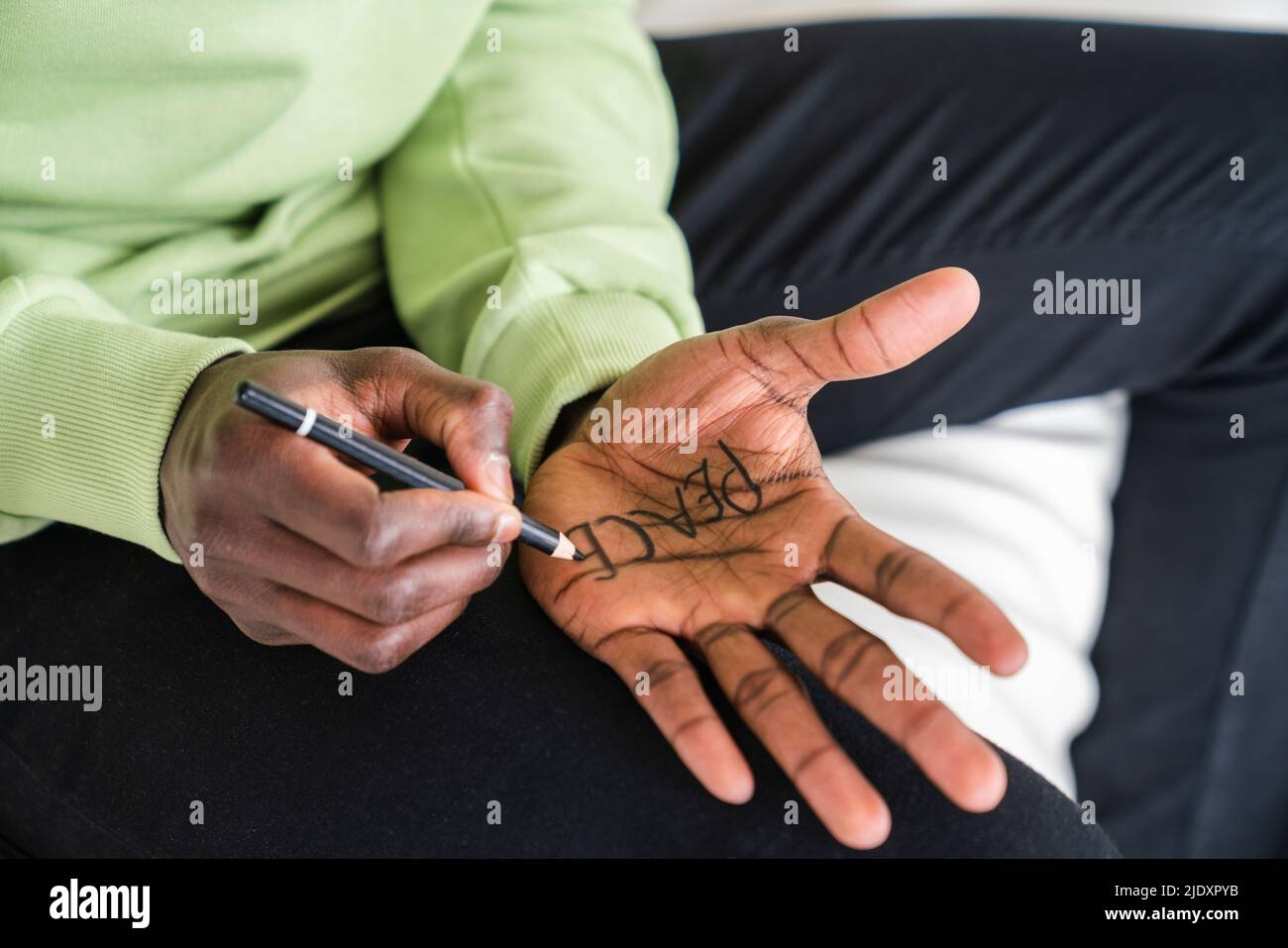 Man writing peace on palm of hand Stock Photo Alamy