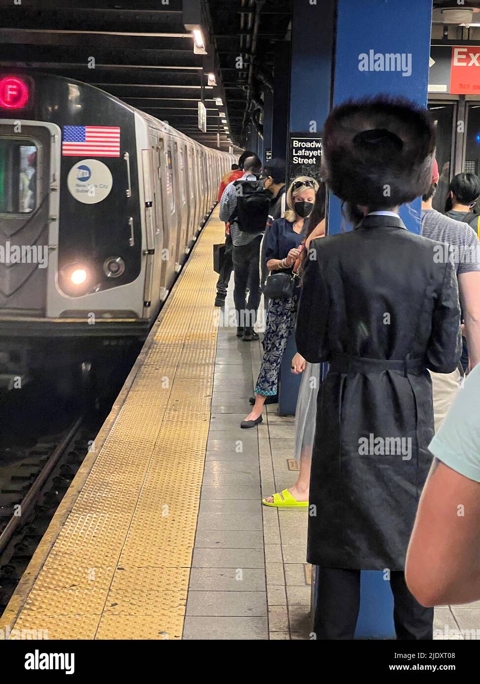 Religious orthodox Jewish man waits for a Brooklyn bound F train at the Broadway Lafayette subway station in Manhattan, New York City. Stock Photo