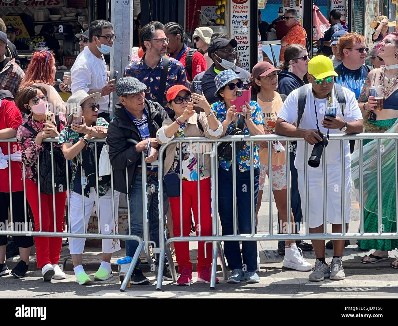 Spectators with video cameras running at the Mermaid Parade along Surf