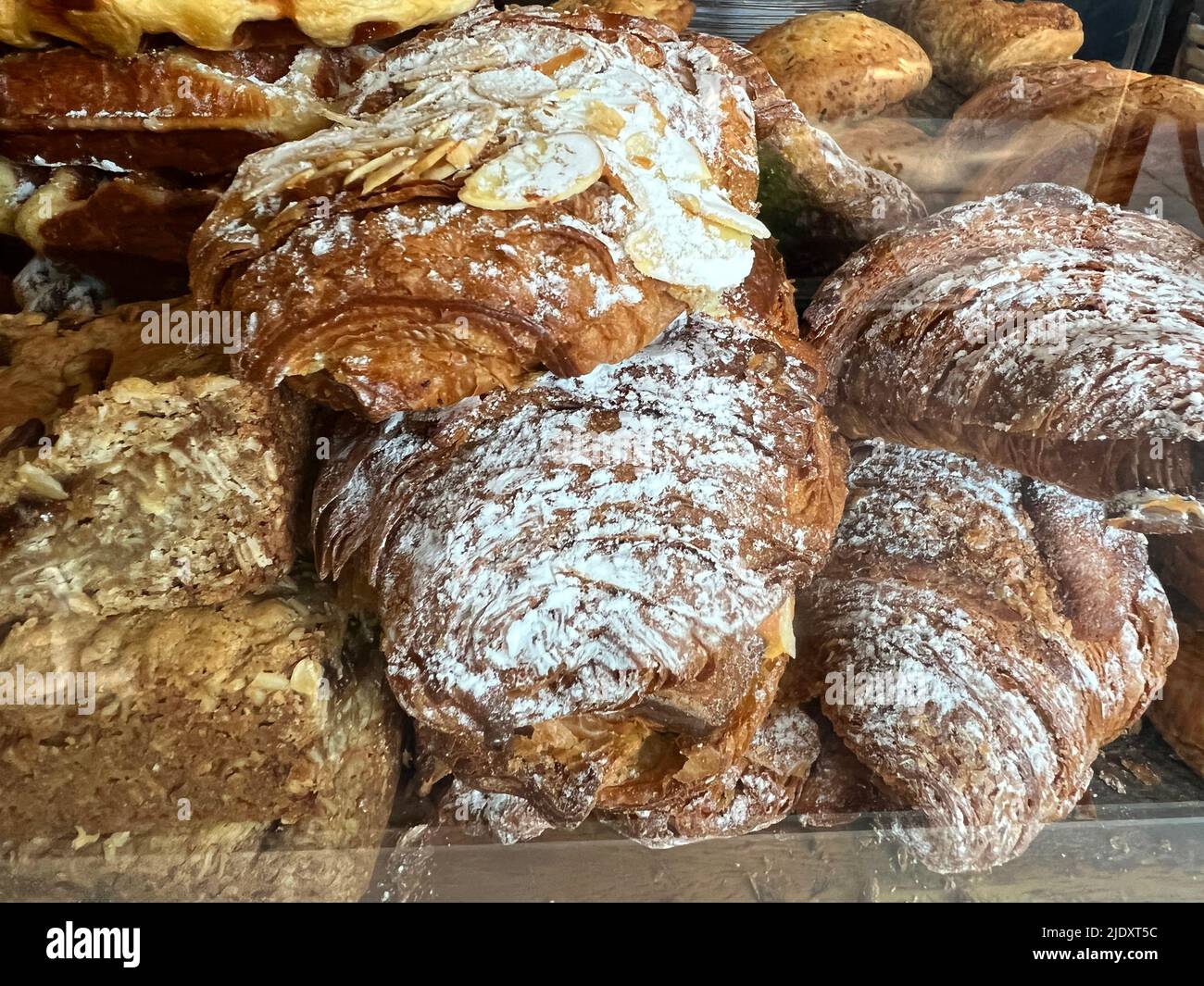 Freshly baked almond croissants sprinkled with powdered sugar at a cafe in Brooklyn, New York. Stock Photo
