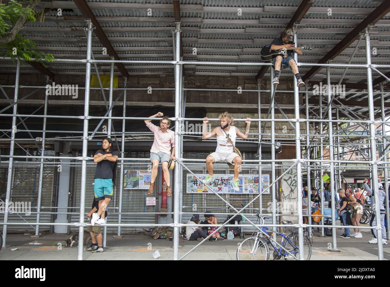 After 2 years from a Covid-19 shutdown, people return to the annual Mermaid Parade, alleged to be the largest art parade in the nation, at Coney Island along Surf Avenue in Brooklyn, New York. Spectstors climb scafolding to get a better view of the parade. Stock Photo