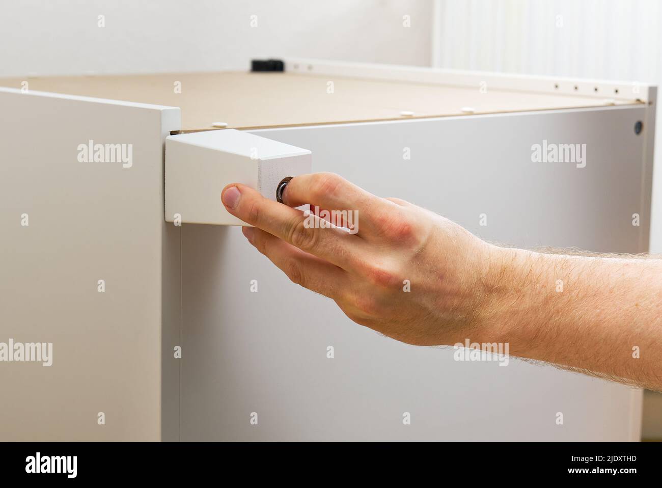 Professional Furniture Assembly Worker Assembles Shelf. Furniture