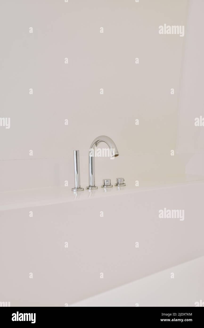 Wall mounted bath mixer tap with chrome elements in traditional design