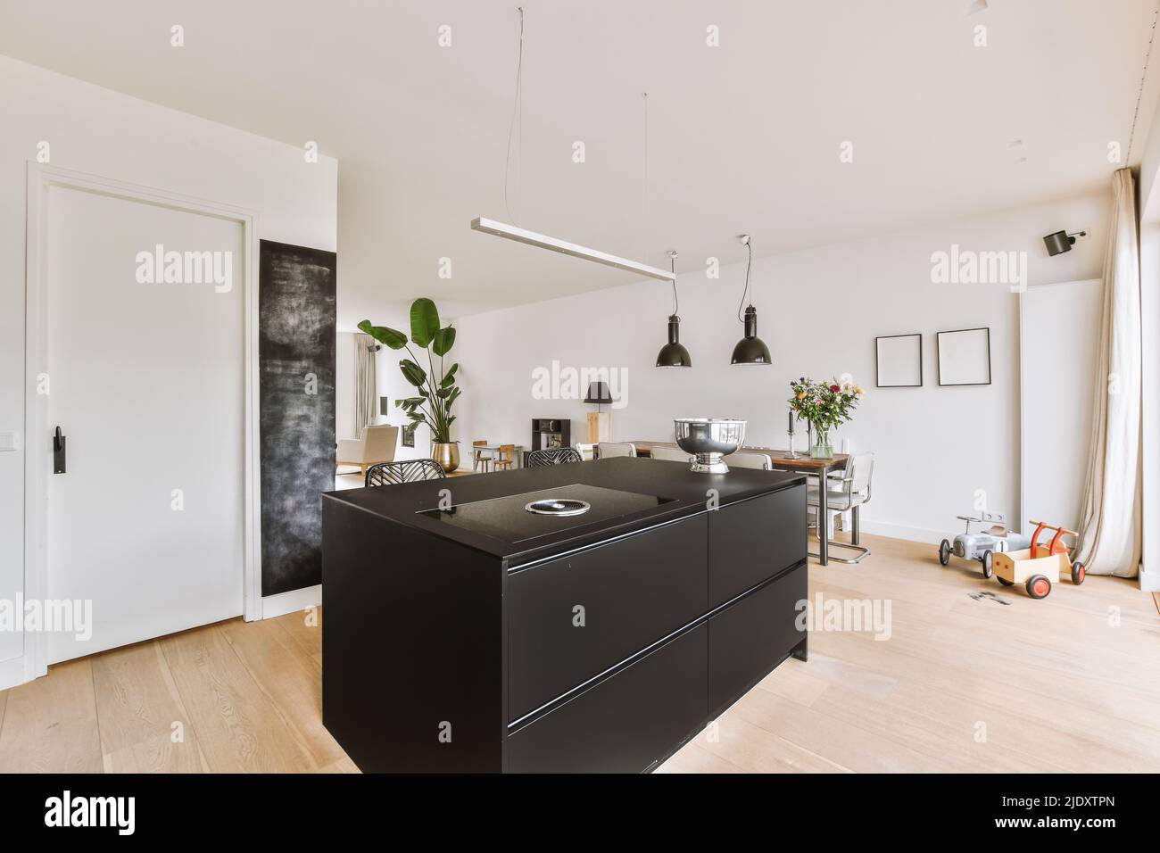 Open plan kitchen design with black countertops and an island in the middle under the lampitchen with island counter Stock Photo