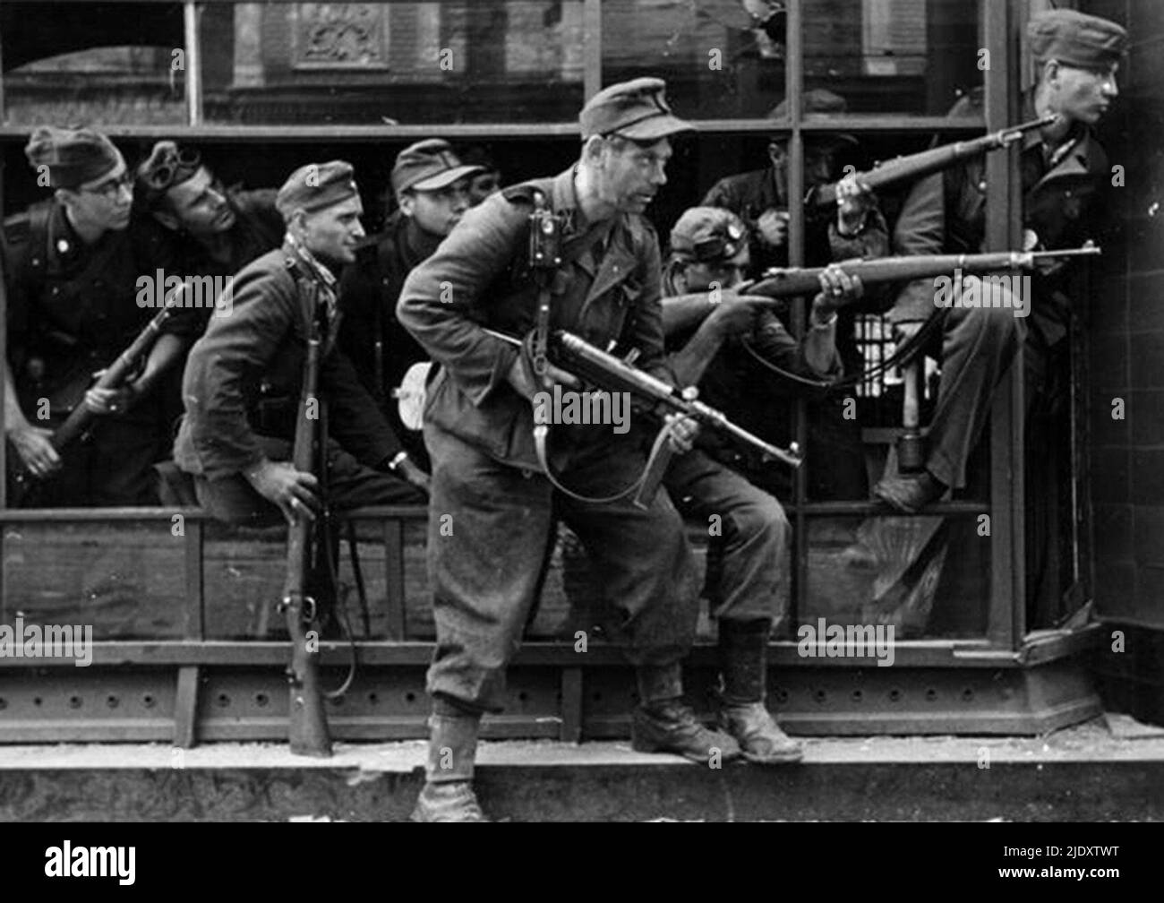 Members of the especially violent Dirlewanger Brigade in action in Warsaw during the 1944 Warsaw Uprising. This unit of the SS was led by Oskar Dirlewanger and was composed of convicted criminals. Even among the SS he was considered as particularly barbaric. The brigade assisted in the execuion of around 100,000 Polish residents of Warsaw, most notably in the appalling violence inflicted in the Wola Massacre. Stock Photo