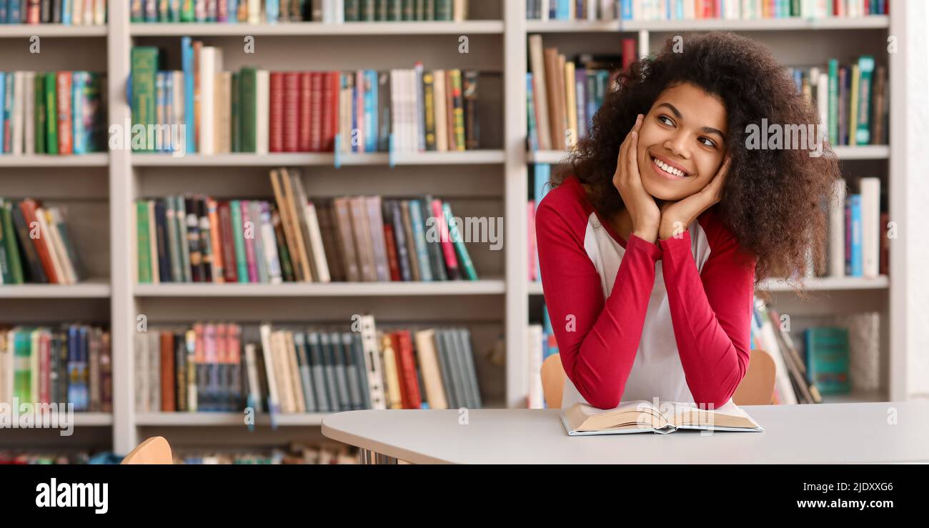 Portrait of pretty African-American student in library Stock Photo - Alamy