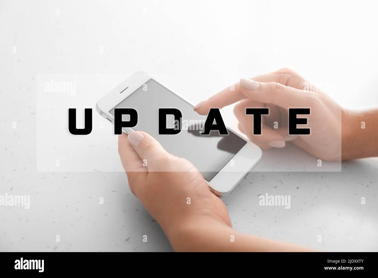 Hands with modern mobile phone on light background, closeup. Update concept Stock Photo