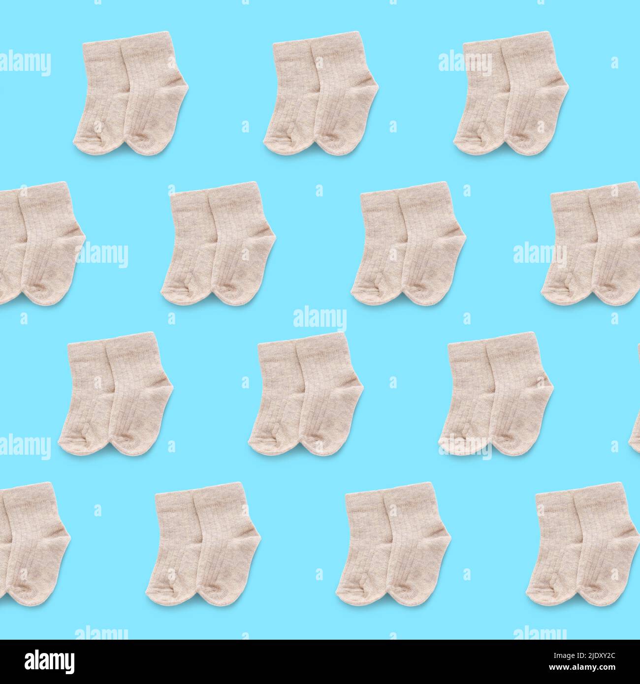 Many baby socks on light blue background. Pattern for design Stock Photo
