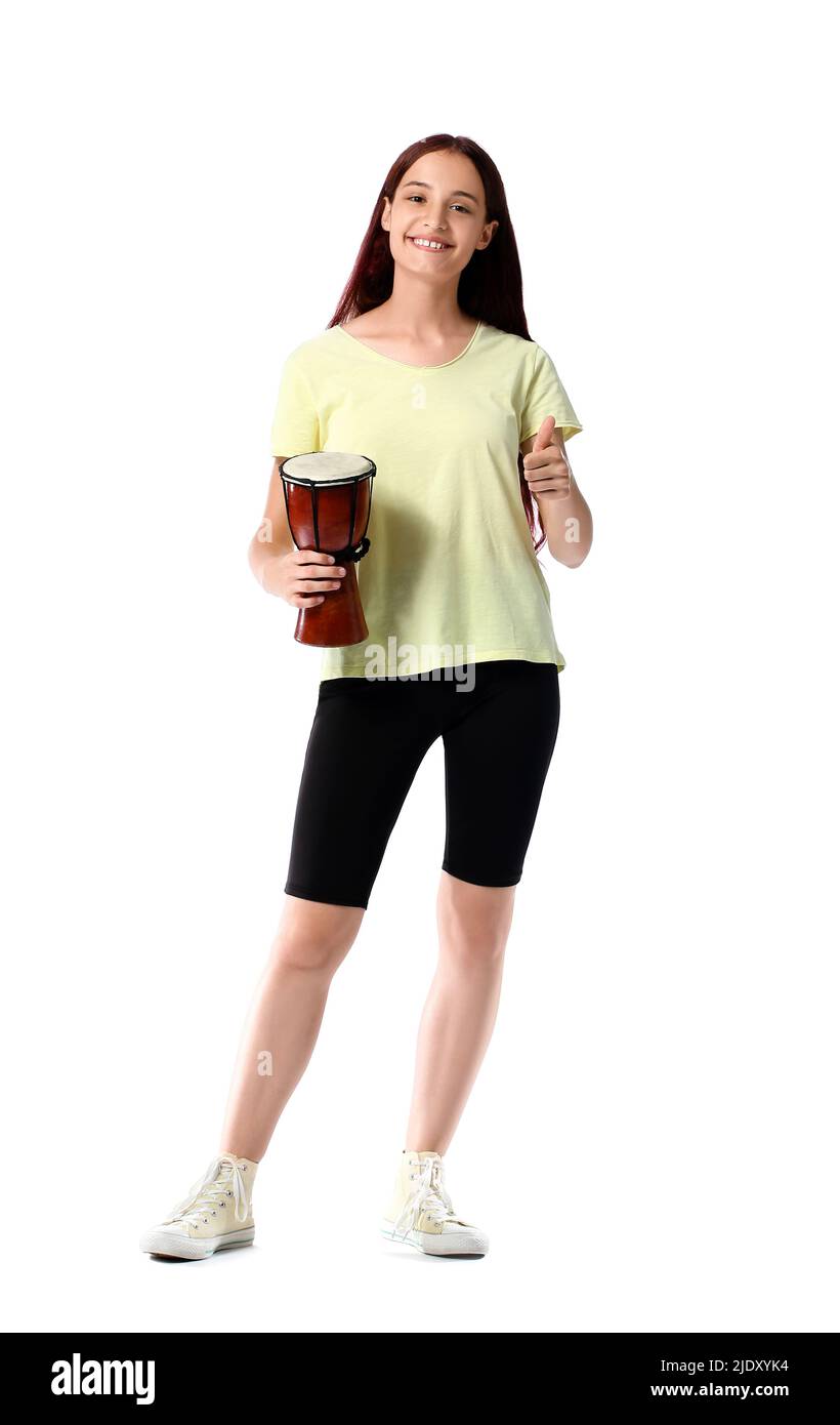 Teenage girl with tam-tam drum showing thumb-up on white background Stock Photo