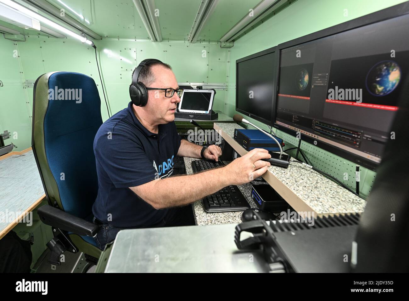 Friedrichshafen, Germany. 23rd June, 2022. Robert Traussnig, DARC  Friedrichshafen chapter chairman, sits in the new emergency response  vehicle and makes radio contact with other radio operators. The former  military container, which houses