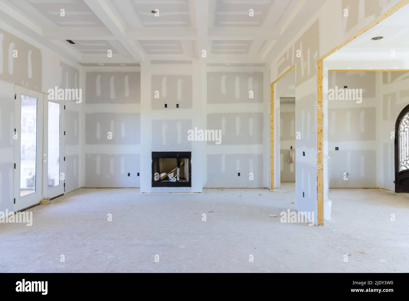 To prepare the walls of a newly constructed house to be painted