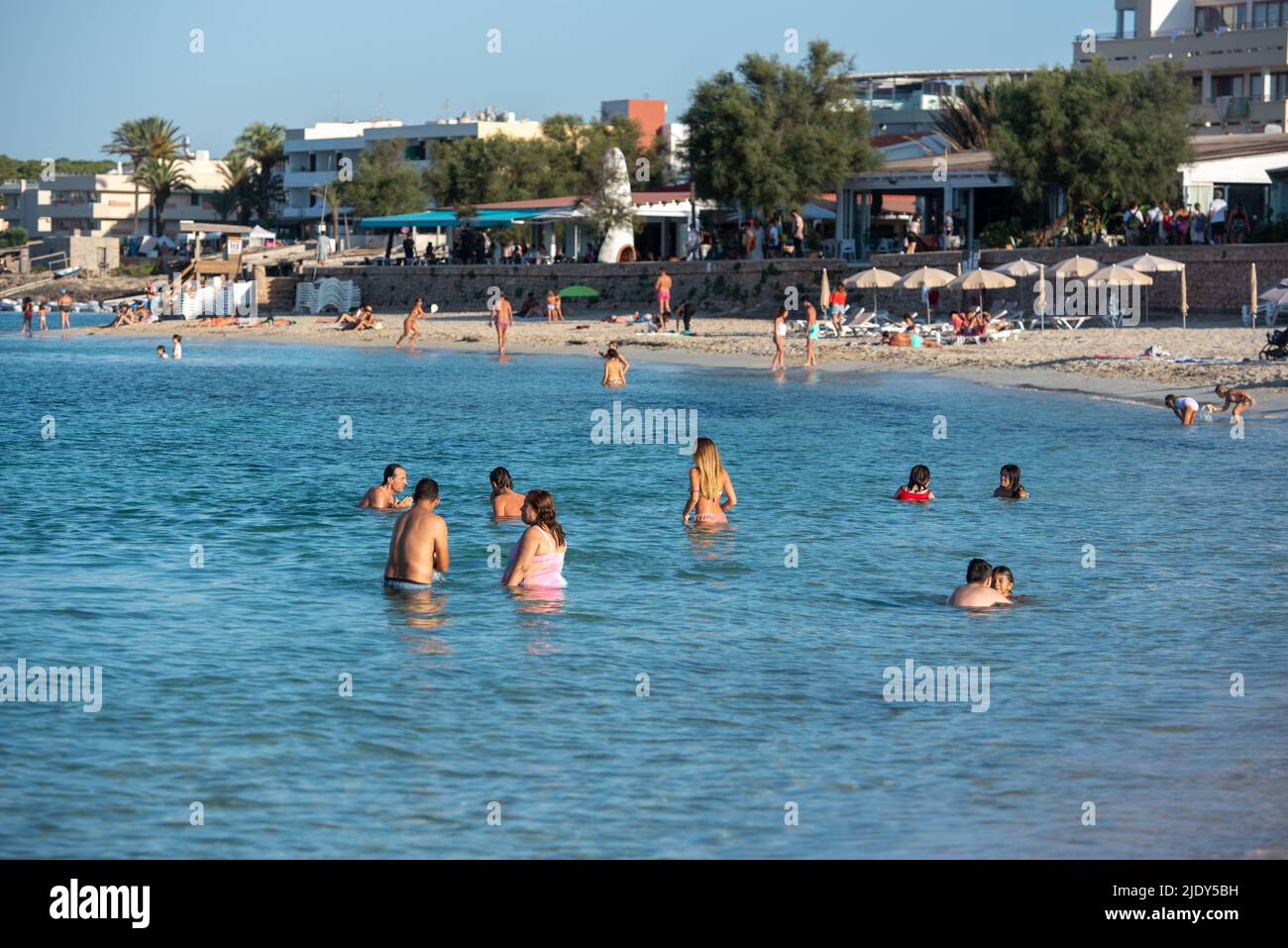 Es Pujols, Formentera, Spain: 2021 August 06: People enjoying the Es Pujols beach in Formentera, Spain in the summer of 2021. Stock Photo