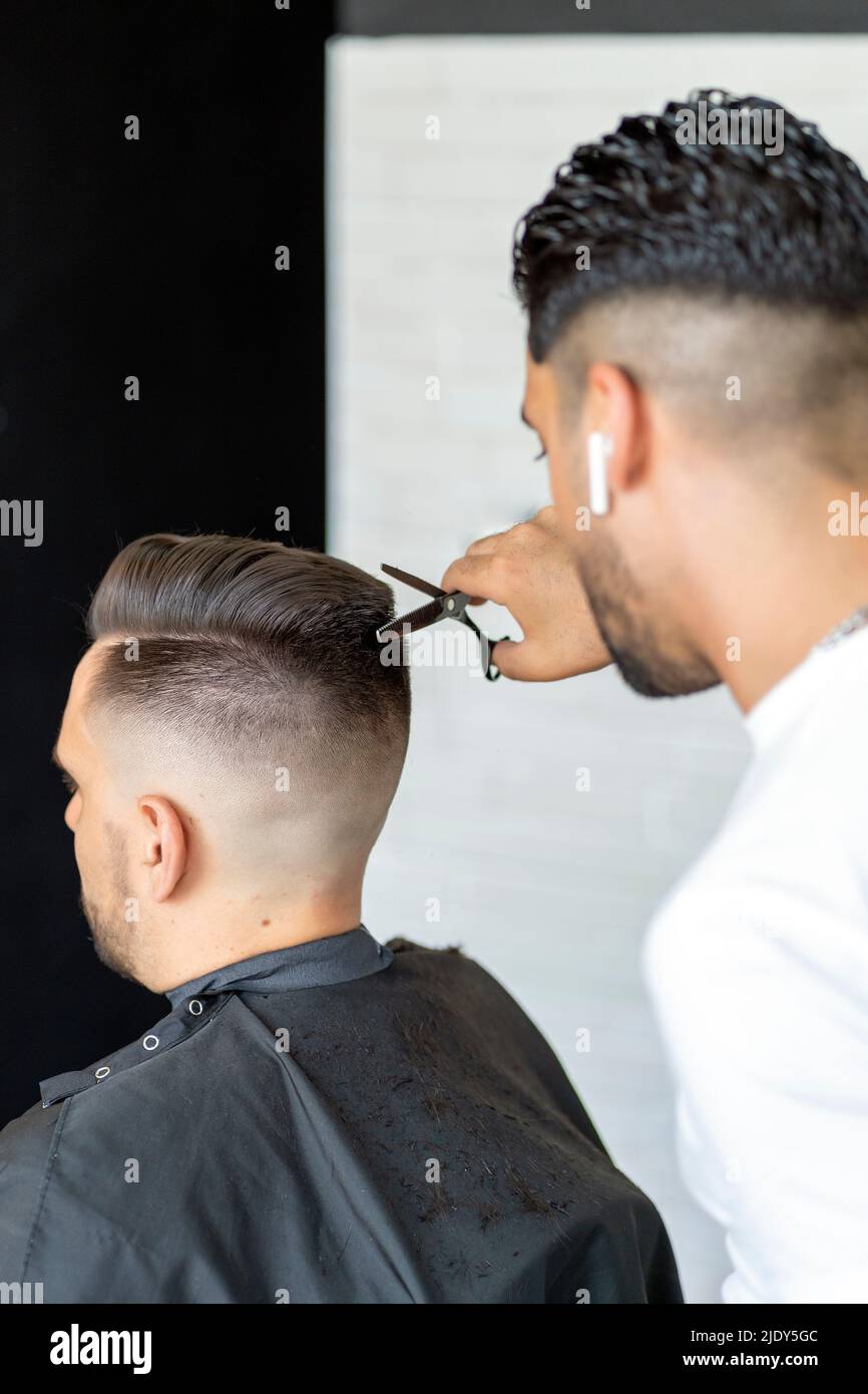 professional barber cutting a man's hair Stock Photo