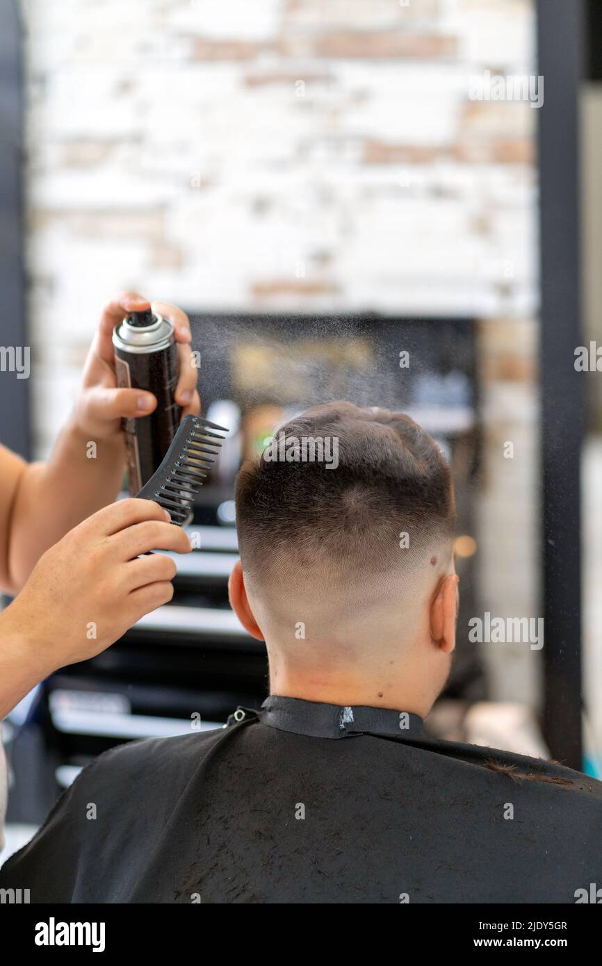 hairdresser cutting a client's hair Stock Photo