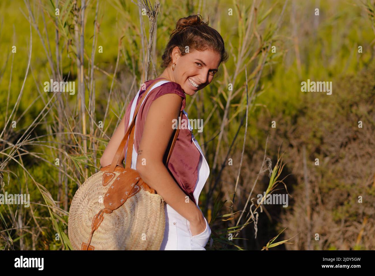 Happy young woman enjoys her travel and vacation outdoors Stock Photo