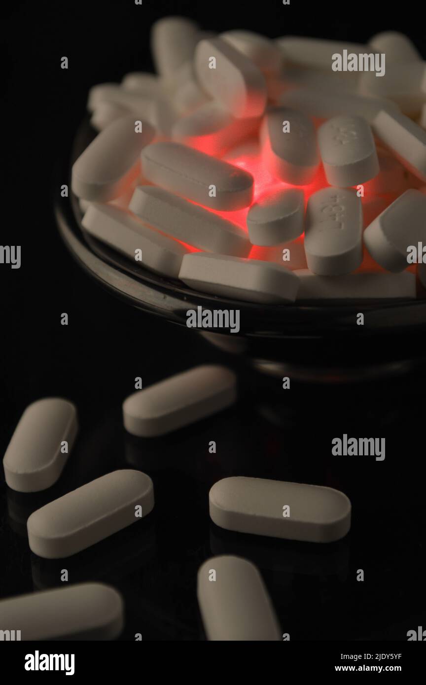 Pills (Acetaminophen) illuminated from within Stock Photo