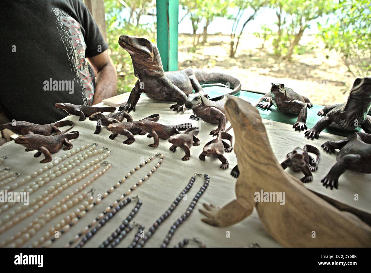 Wooden sculptures of komodo dragon at a souvenir stall in in Komodo