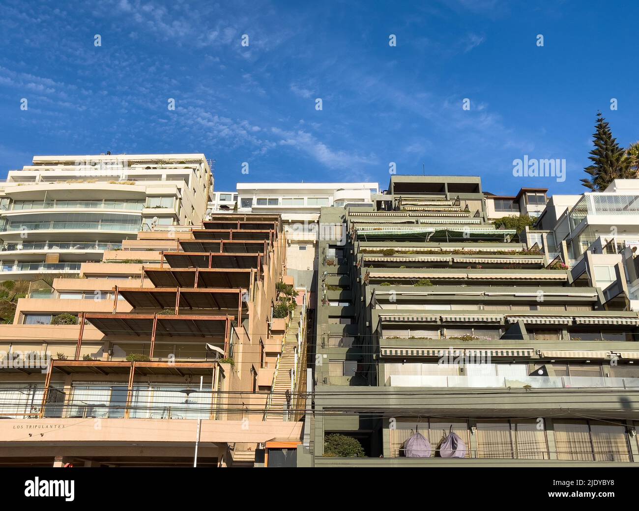 Summer vacation complex of stepped apartment buildings on hill side in Reñaca coast, Chile. Sunny day on tourism destination in Valparaiso region Stock Photo