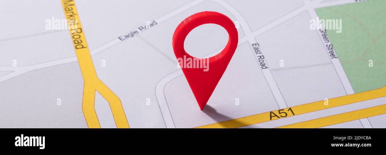 High Angle View Of Navigation Map With Red Pin Pointer Stock Photo